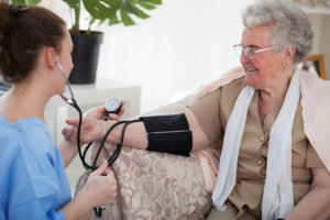 nurse checking blood pressure